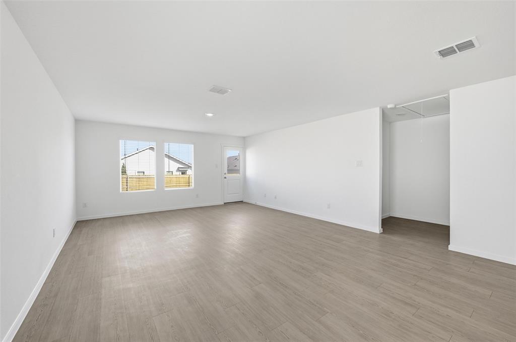 3707 Spring Run Drive Sherman, TX 75092 - Photo 9 of 18 an empty room with wooden floor and windows