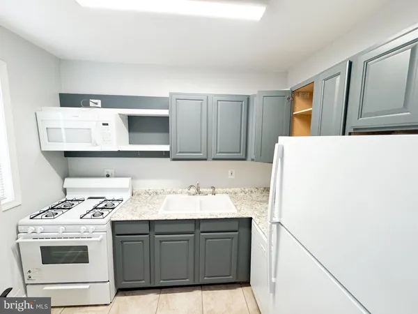 a kitchen with a sink and a stove top oven
