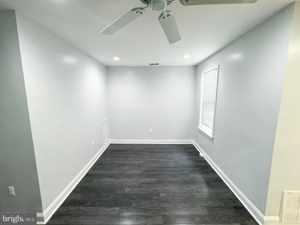 wooden floor in a hall with a window