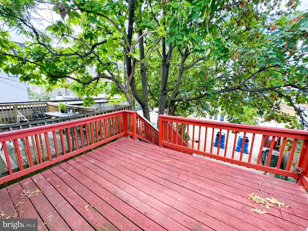 a balcony with wooden floor and trees