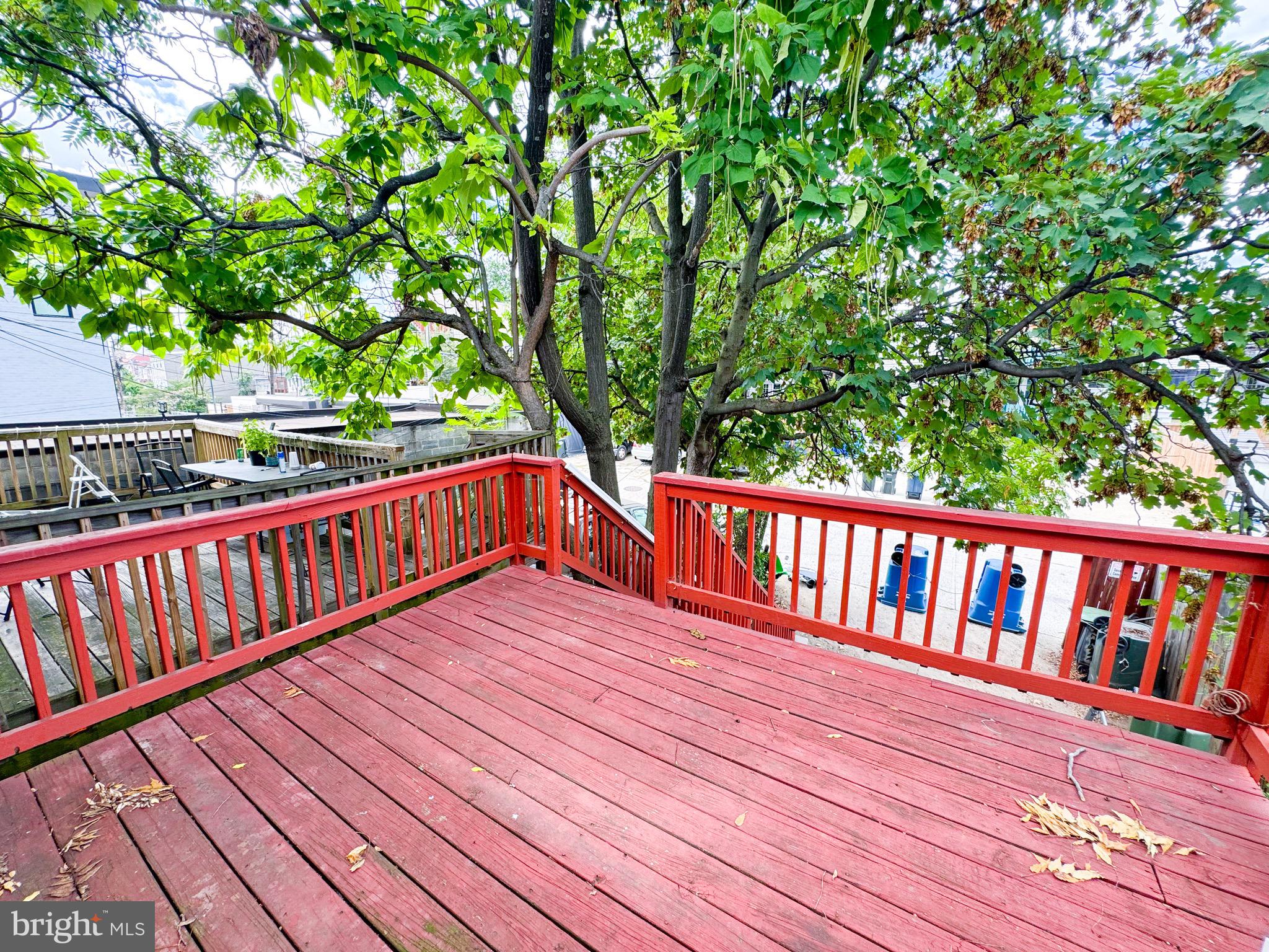 719 Euclid Street Northwest, Unit 4 Washington, DC 20001 - Photo 8 of 9 a balcony with wooden floor and trees
