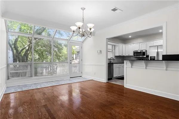 a view of a kitchen with wooden floor and a large window
