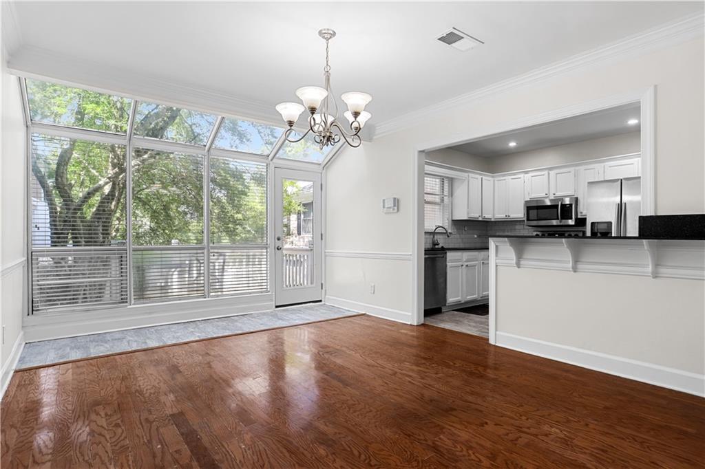 a view of a kitchen with wooden floor and a large window
