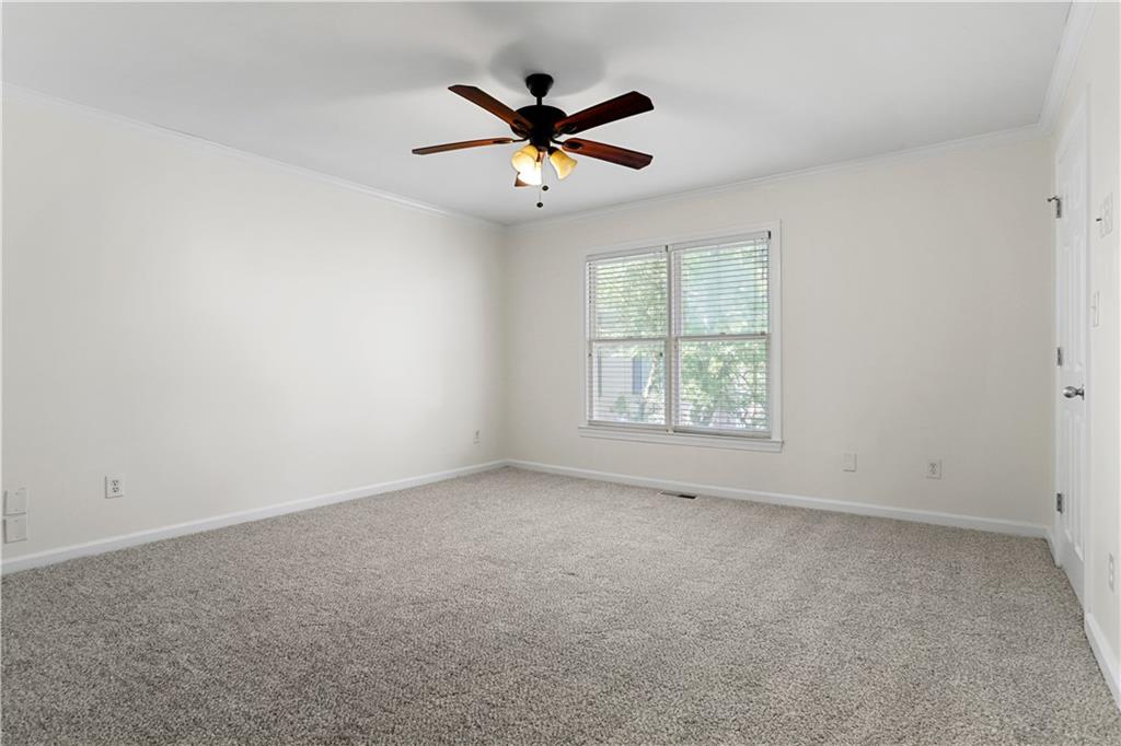 7500 Roswell Road, Unit 78 Atlanta, GA 30350 - Photo 13 of 22 an empty room with ceiling fan and windows