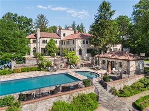an aerial view of a house with a garden and lake view