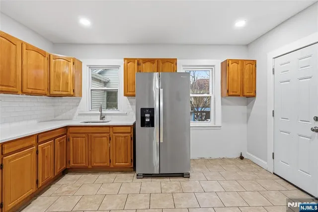 a kitchen with stainless steel appliances granite countertop a refrigerator and a sink