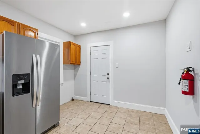 a view of walk in closet with window and refrigerator