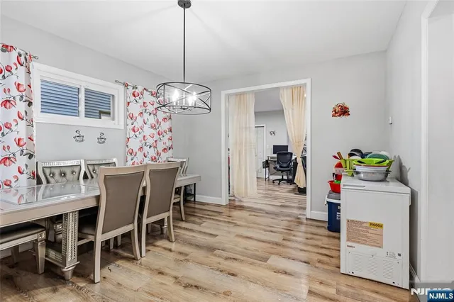 a view of a dining room with furniture and chandelier