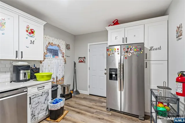 a kitchen with stainless steel appliances a refrigerator and a stove