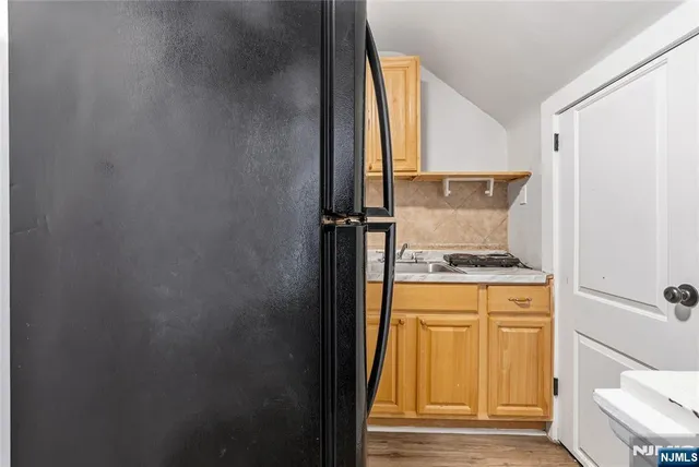 a kitchen with a refrigerator and cabinets