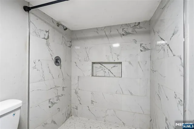 a bathroom with a shower toilet and sink