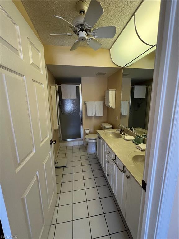 185 Grand Oaks Way, Unit R204 Naples, FL 34110 - Photo 16 of 18 a bathroom with a sink a mirror and a shower