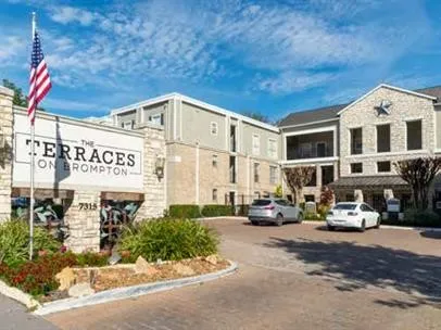 a view of a building with car parked