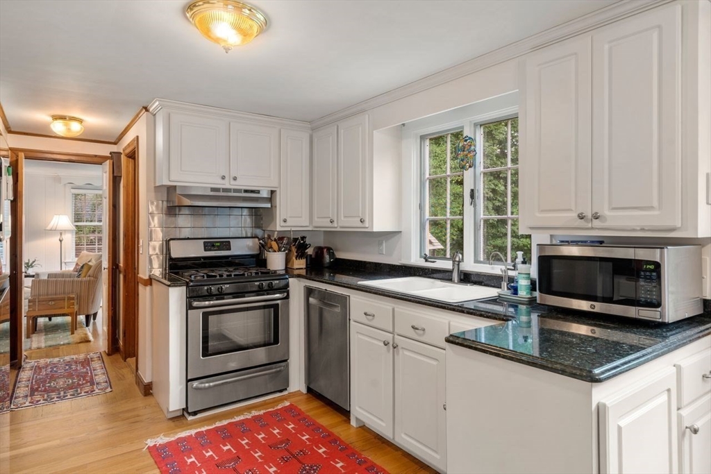 11 Nantucket Road Wellesley, MA 02481 - Photo 11 of 23 a kitchen with stainless steel appliances granite countertop a sink a stove a microwave and cabinets