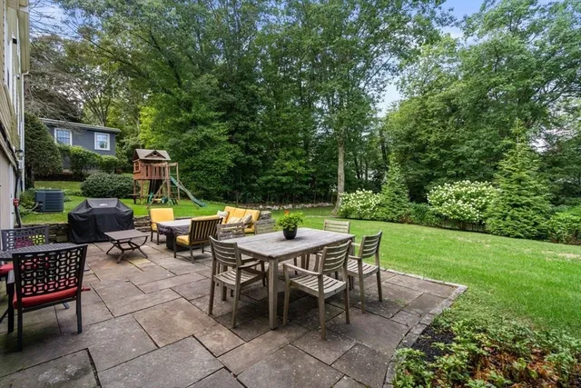 a backyard of a house with outdoor seating