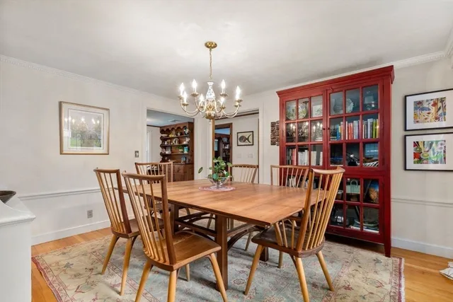 a view of a dining room with furniture and chandelier