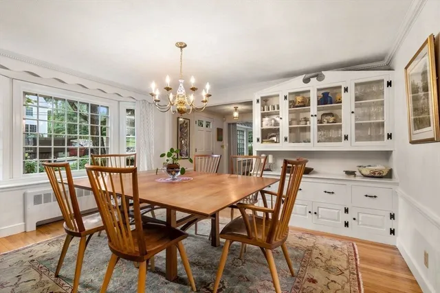 a view of a dining room with furniture and chandelier