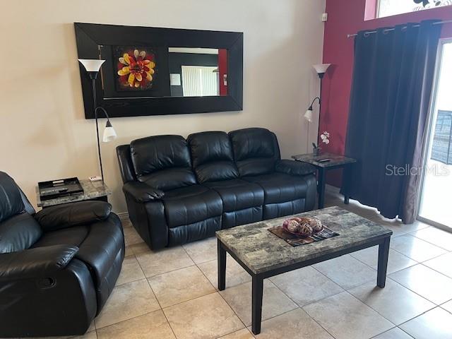 2533 Oneida Loop Kissimmee, FL 34747 - Photo 14 of 73 a living room with furniture and a flat screen tv