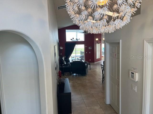 2533 Oneida Loop Kissimmee, FL 34747 - Photo 15 of 73 a hallway with a flower pot and a bookshelf