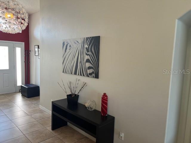 2533 Oneida Loop Kissimmee, FL 34747 - Photo 17 of 73 a view of hallway with a potted plant on the wall and a window