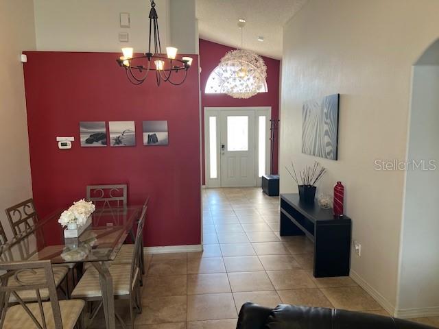 2533 Oneida Loop Kissimmee, FL 34747 - Photo 18 of 73 a living room with furniture and a chandelier