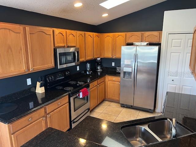 2533 Oneida Loop Kissimmee, FL 34747 - Photo 19 of 73 a kitchen with stainless steel appliances granite countertop a refrigerator a stove and a sink with wooden floor