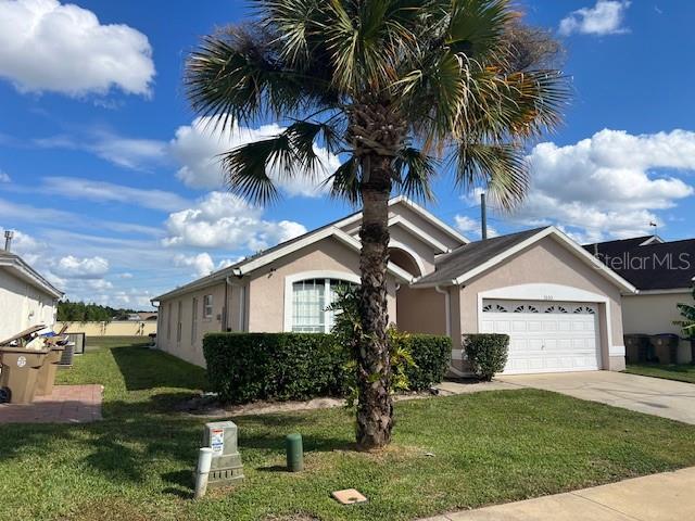 2533 Oneida Loop Kissimmee, FL 34747 - Photo 2 of 73 a front view of a house with a garden