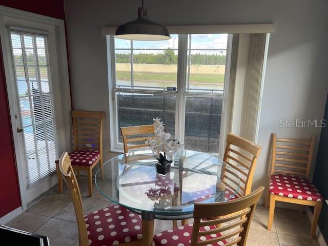 2533 Oneida Loop Kissimmee, FL 34747 - Photo 23 of 73 a view of a dining room with furniture wooden floor and a chandelier
