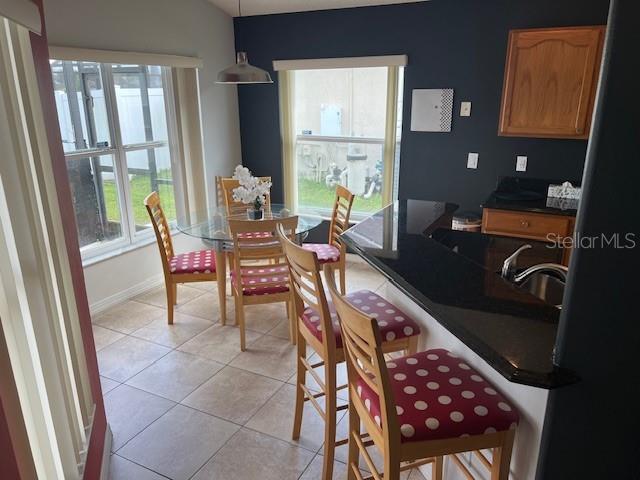 2533 Oneida Loop Kissimmee, FL 34747 - Photo 27 of 73 a dining room with furniture and a floor to ceiling window