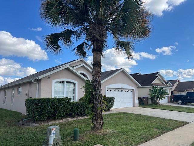 2533 Oneida Loop Kissimmee, FL 34747 - Photo 3 of 73 a view of house with a yard and potted plants