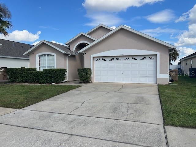 2533 Oneida Loop Kissimmee, FL 34747 - Photo 4 of 73 a front view of a house with a yard and garage