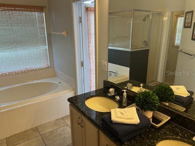 2533 Oneida Loop Kissimmee, FL 34747 - Photo 43 of 73 a bathroom with a granite countertop sink and a mirror