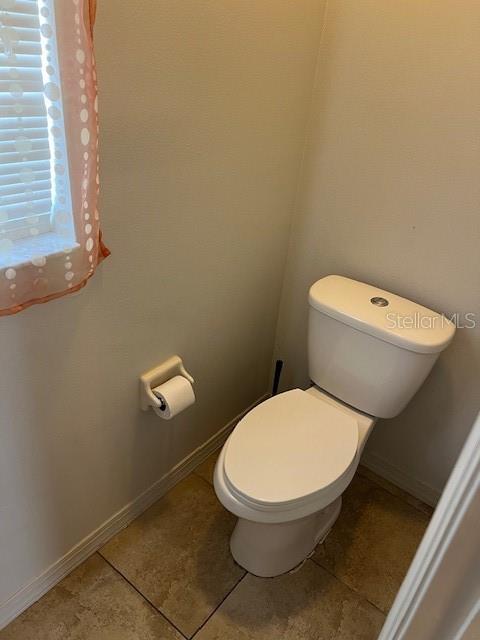 2533 Oneida Loop Kissimmee, FL 34747 - Photo 48 of 73 a white toilet sitting next to a window