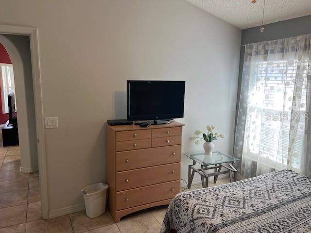 2533 Oneida Loop Kissimmee, FL 34747 - Photo 52 of 73 a bedroom with a bed and flat screen tv