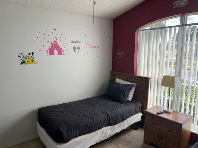 2533 Oneida Loop Kissimmee, FL 34747 - Photo 61 of 73 a bedroom with a bed and a window