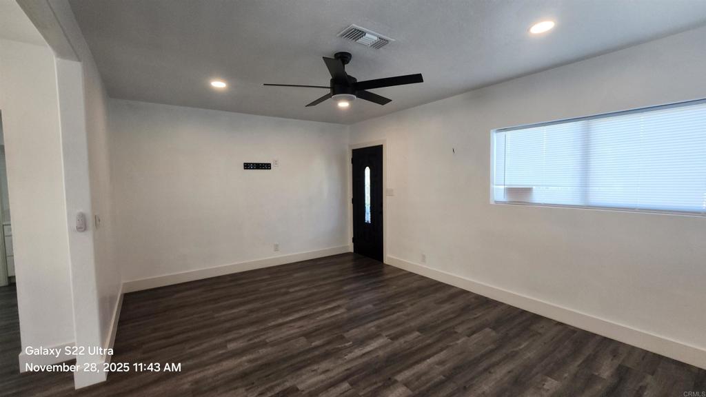 1303 Center Avenue Oceanside, CA 92054 - Photo 2 of 15 a view of an empty room with wooden floor and a ceiling fan