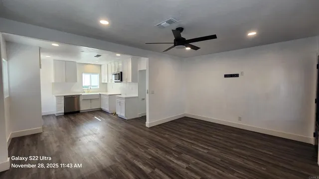 a view of a kitchen with a sink and a stove top oven
