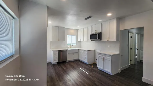 a kitchen with sink cabinets and wooden floor