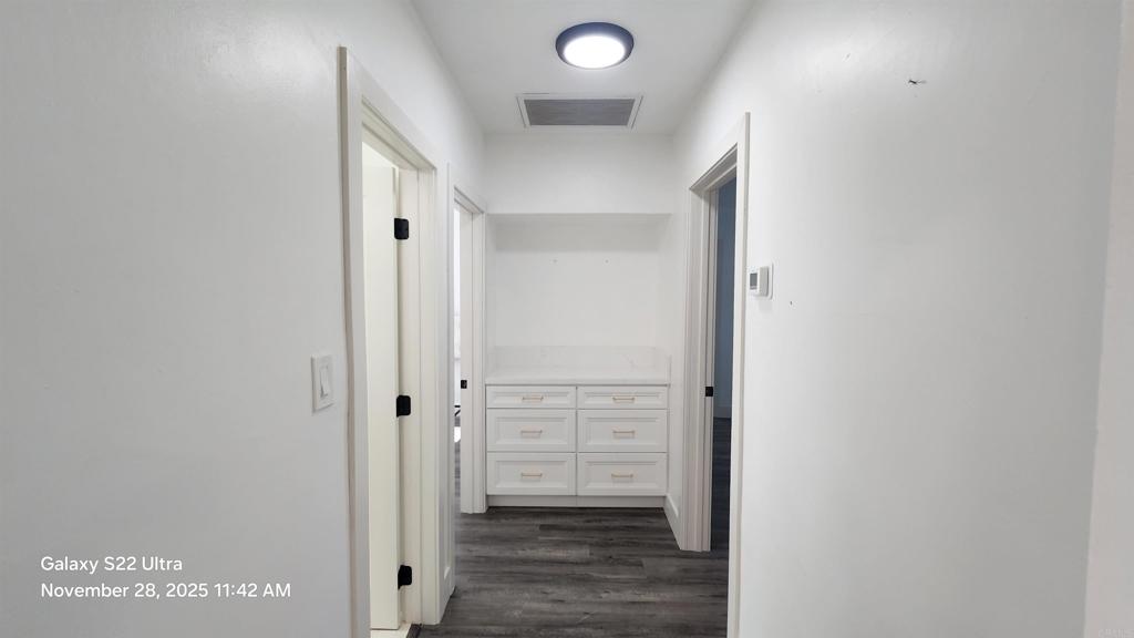 1303 Center Avenue Oceanside, CA 92054 - Photo 6 of 15 a view of a hallway with wooden floor