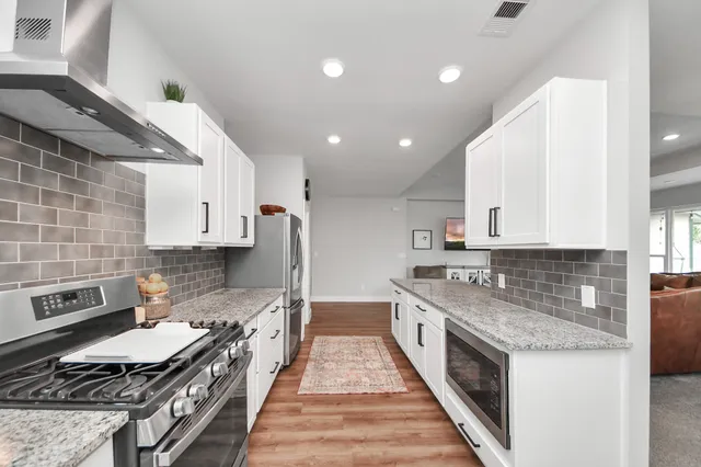 a large kitchen with a stove and a sink