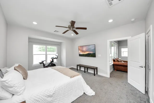 a bed room with a bed and a chair