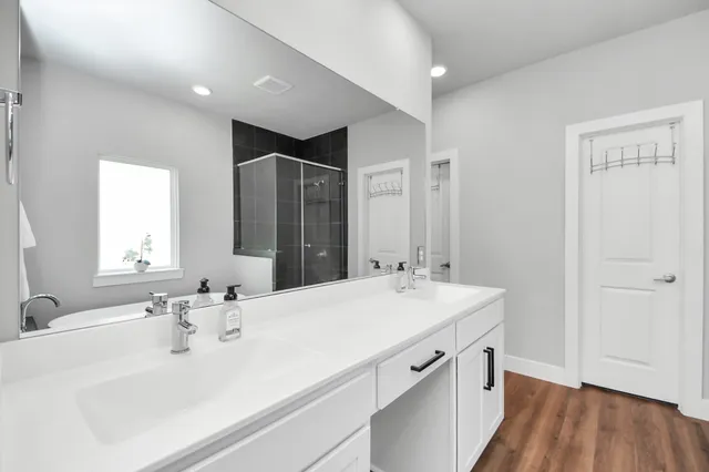 a bathroom with a sink double vanity and a mirror