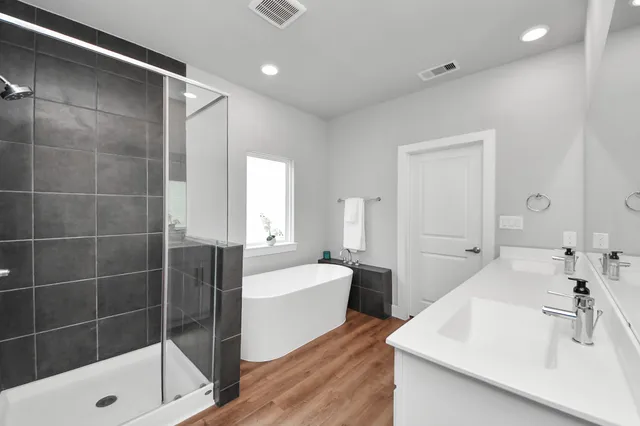 a bathroom with a tub sink and shower