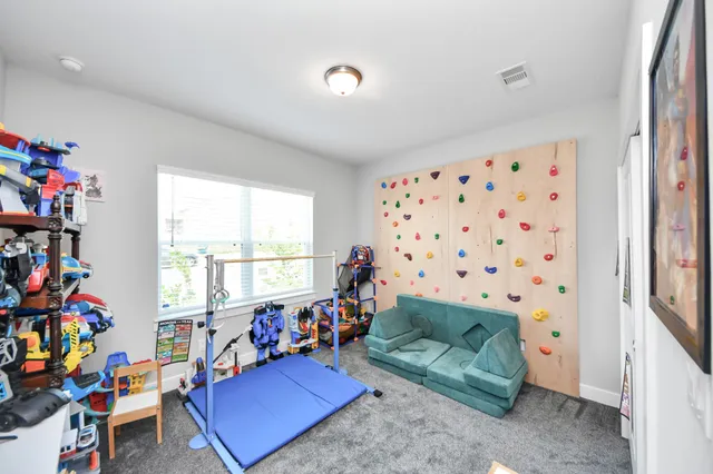 a living room with furniture a baby crib and a couch