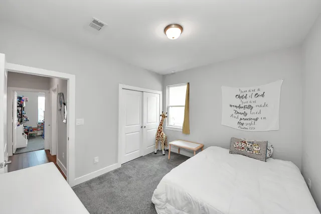 a bedroom with a bed and a large mirror