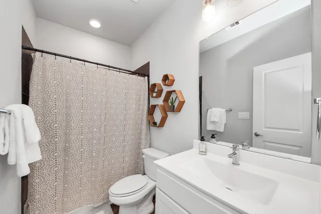 a bathroom with a sink toilet and shower