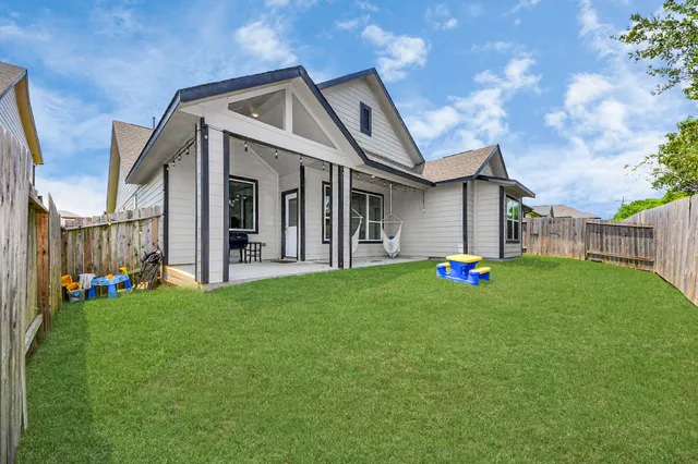 a front view of a house with a garden and yard