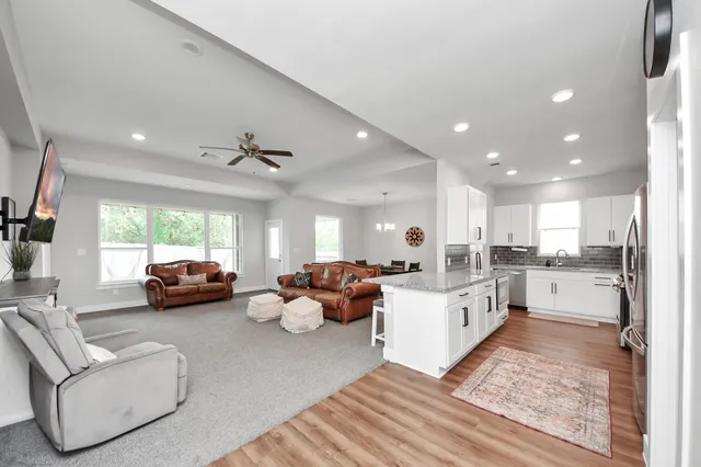 a living room with furniture and a large window