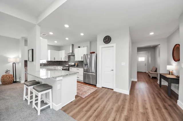 a kitchen with a sink appliances and cabinets