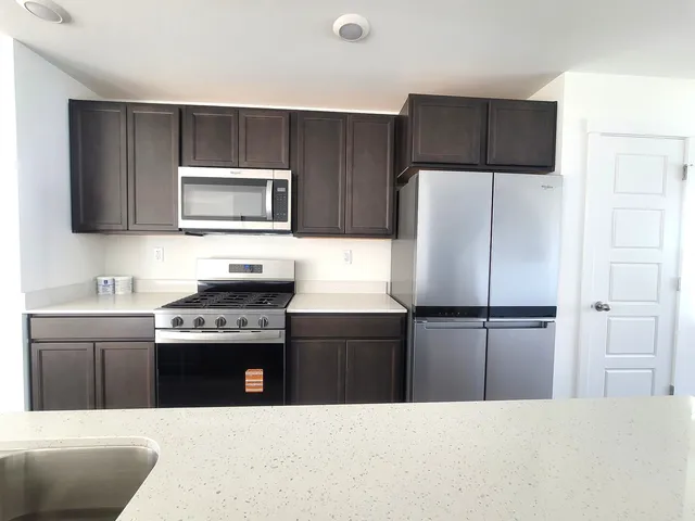 a kitchen with a refrigerator stove and sink